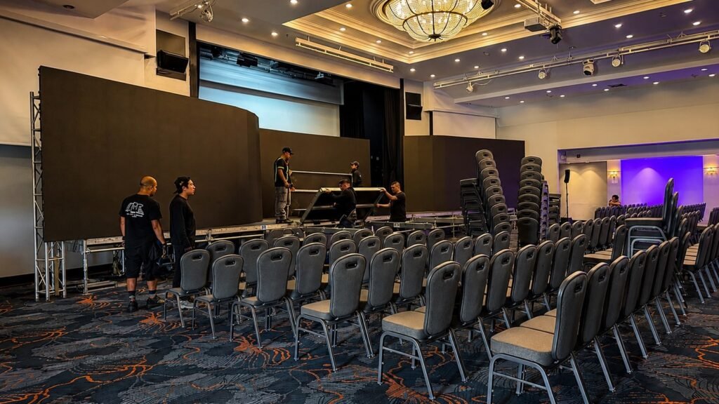 Professional conference stage setup during event production in Costa Rica showing stage construction, seating layout and operational coordination.