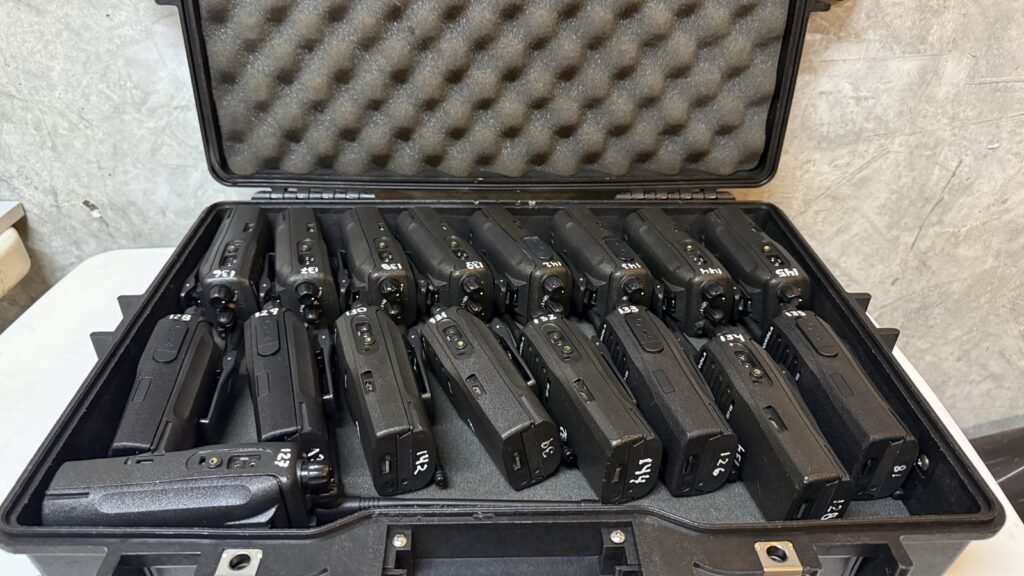 Standardized Motorola portable radios organized inside a Pelican transport case, prepared for temporary mission-critical communication deployments in Costa Rica.