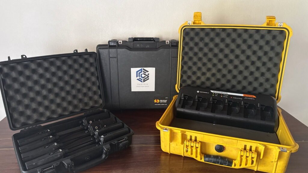 Portable radio kits, protective cases and multi-unit charging equipment prepared for operational deployment by Pacific Operations Group in Costa Rica.