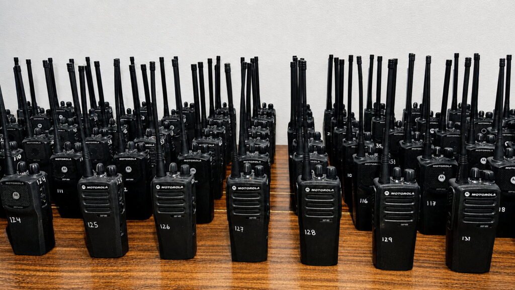 Large organized inventory of portable two-way radios illustrating scalable communication capacity for temporary operations in Costa Rica.